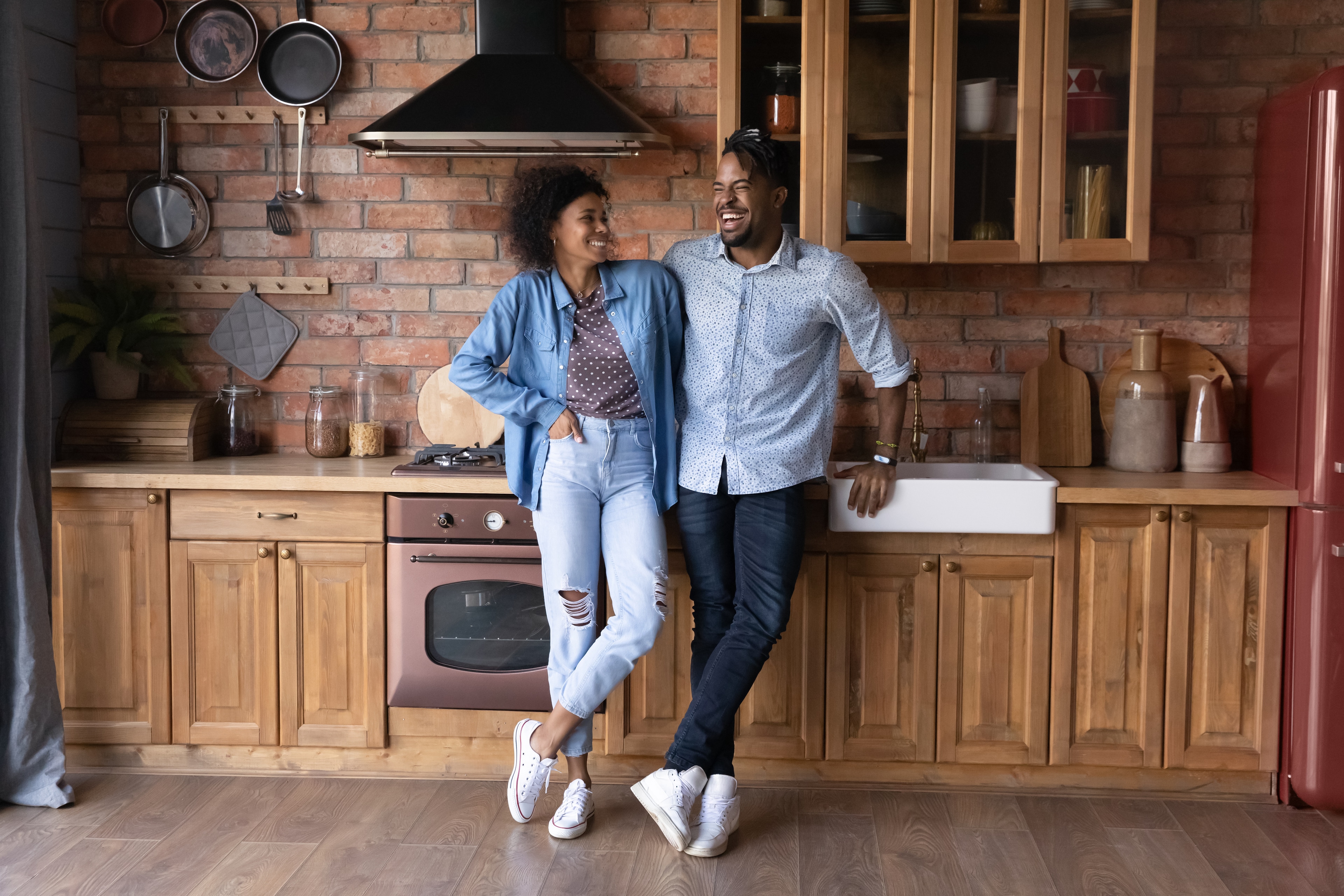 A man and woman standing in a kitchen