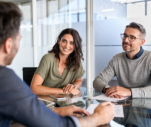 Couple chatting with a lending team expert about their auto loan