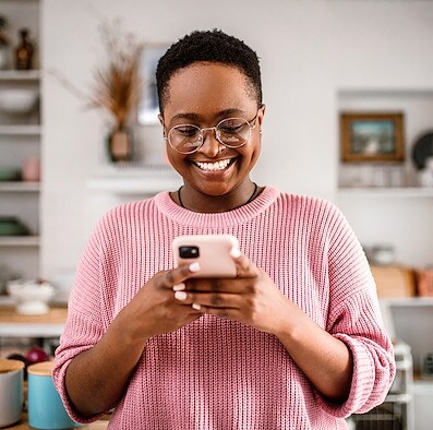 Smiling woman setting up direct deposit on her phone