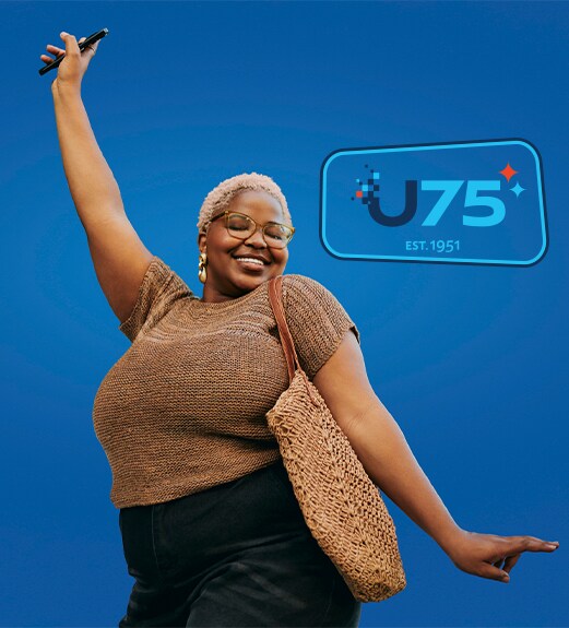 Smiling woman striking a dance pose in celebration