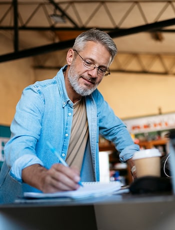Business owner taking notes in his office
