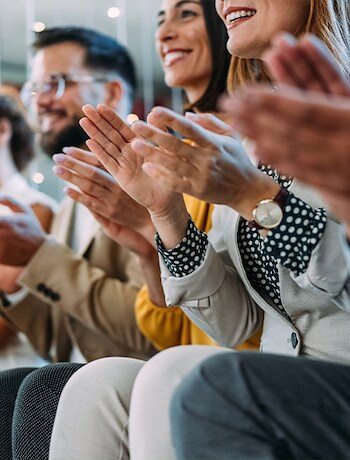 Crowd applauding accepting award