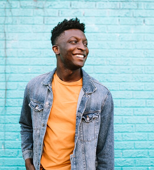 Confident young man smiling and looking ahead