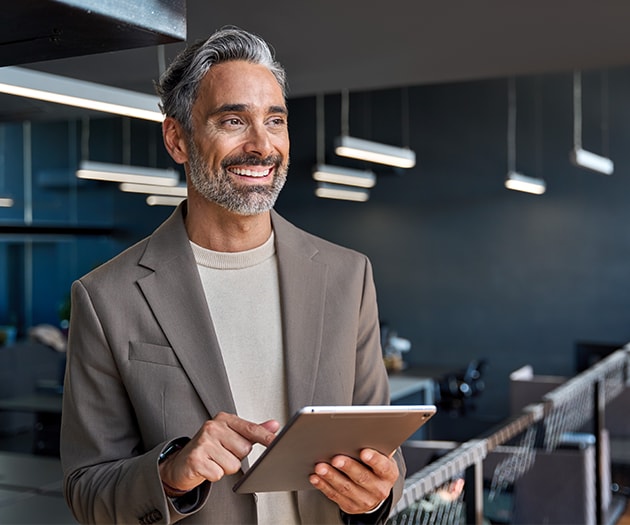 Tech business manager smiling in the office