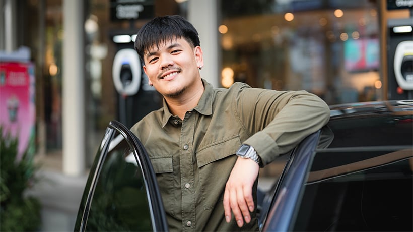 Man standing beside car
