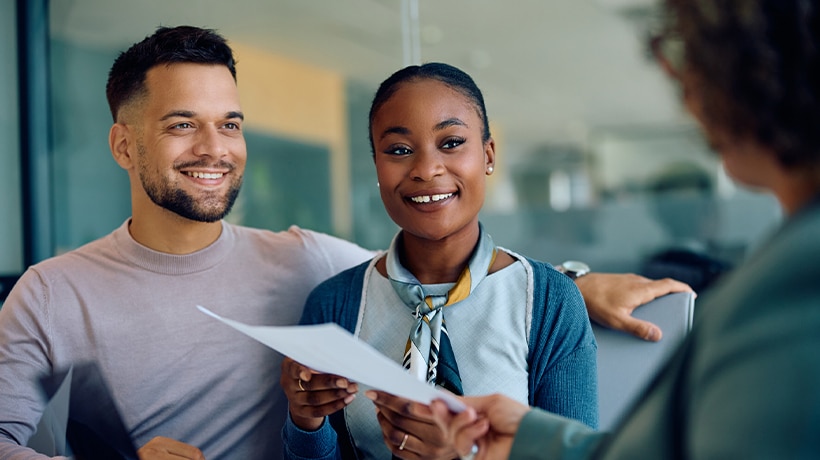 Couple closing a deal with a real estate agent