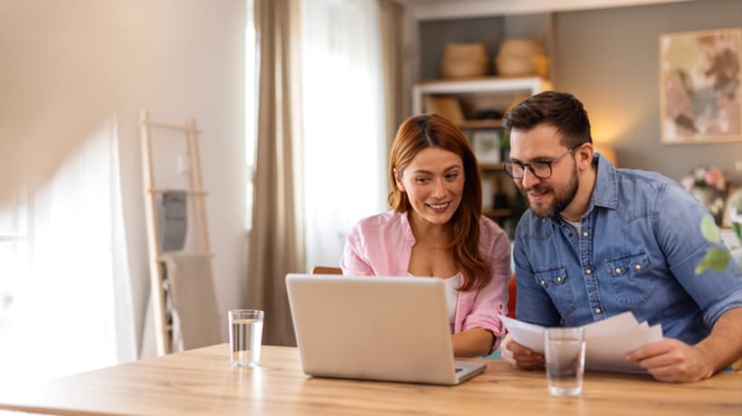 Young couple looking at their laptop