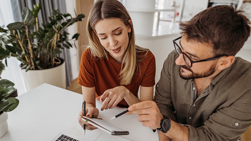 Couple reviewing credit scores together at a desk