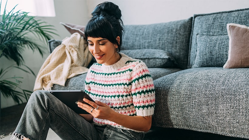 Young renter in her home looking at home buying options online
