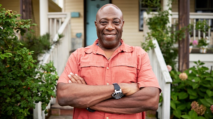 Man standing confidently outside his front door