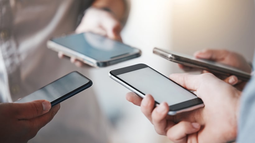 Friends phones grouped together making a Zelle transfer