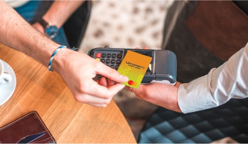 A person using a credit card to pay for a credit card