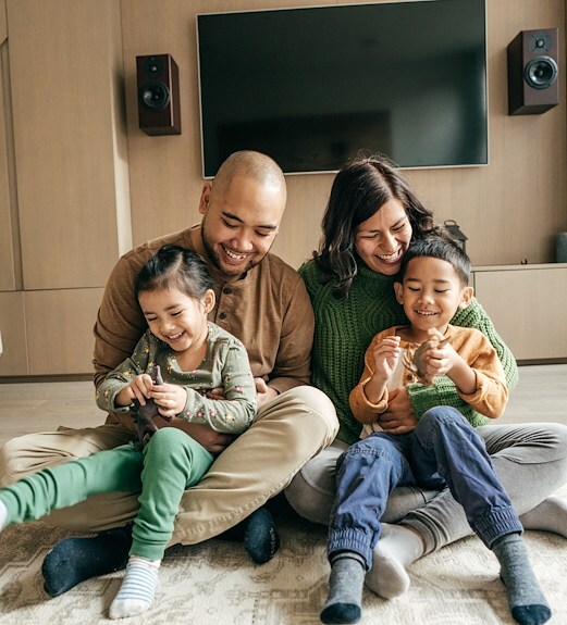 Mother and father playing with their children in the living room