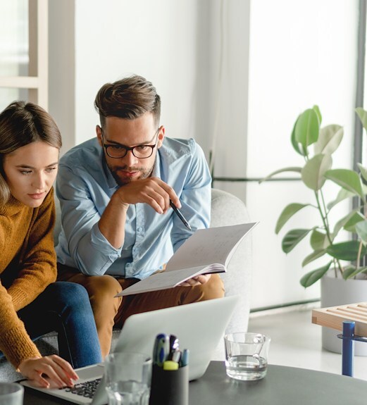 Young couple reviewing their financial details together on a laptop