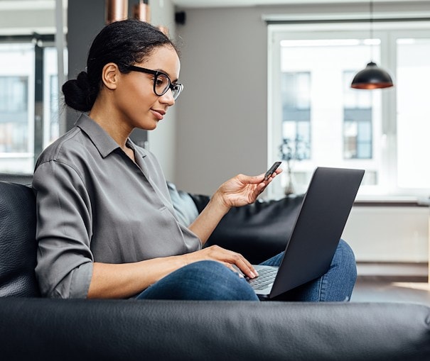 Young woman reviewing consolidation loan options on her laptop