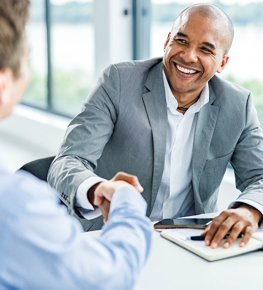 Happy man shaking hands with a financial advisor