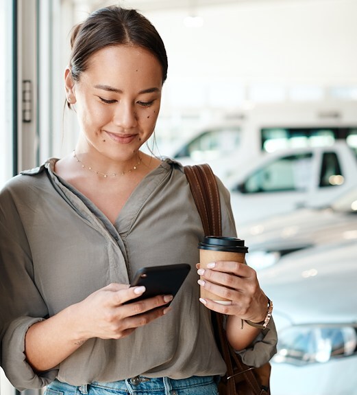 Young woman on the go checking her account on her phone