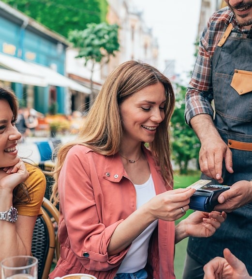 Woman using her credit card to pay a restaurant check