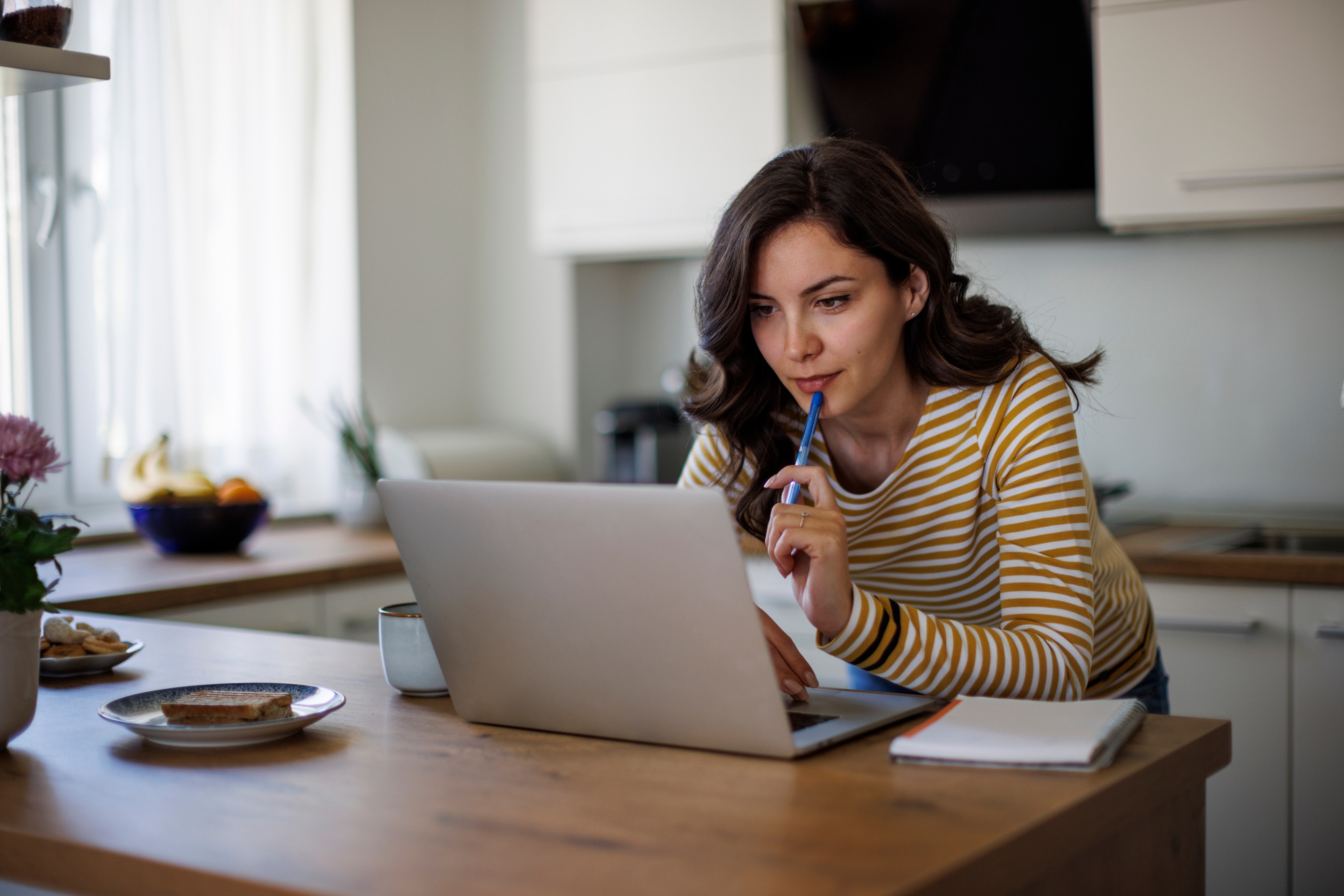 Woman looking intently at her laptop making financial plans