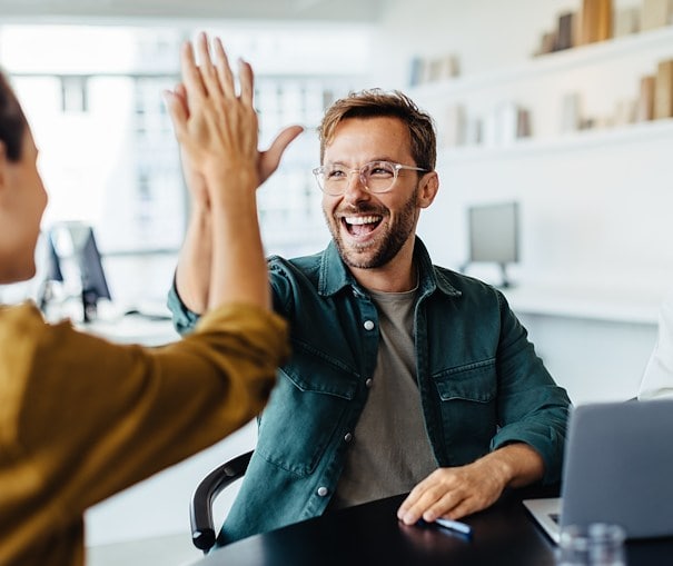 Two people excitedly high-fiving each other