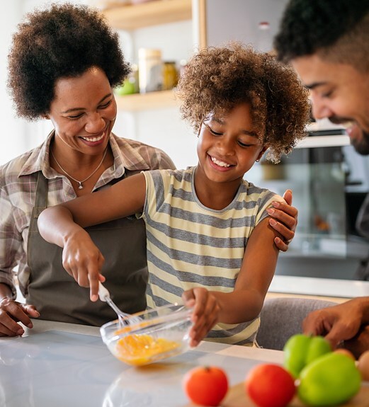 A family cooking together in the kitchen in their home