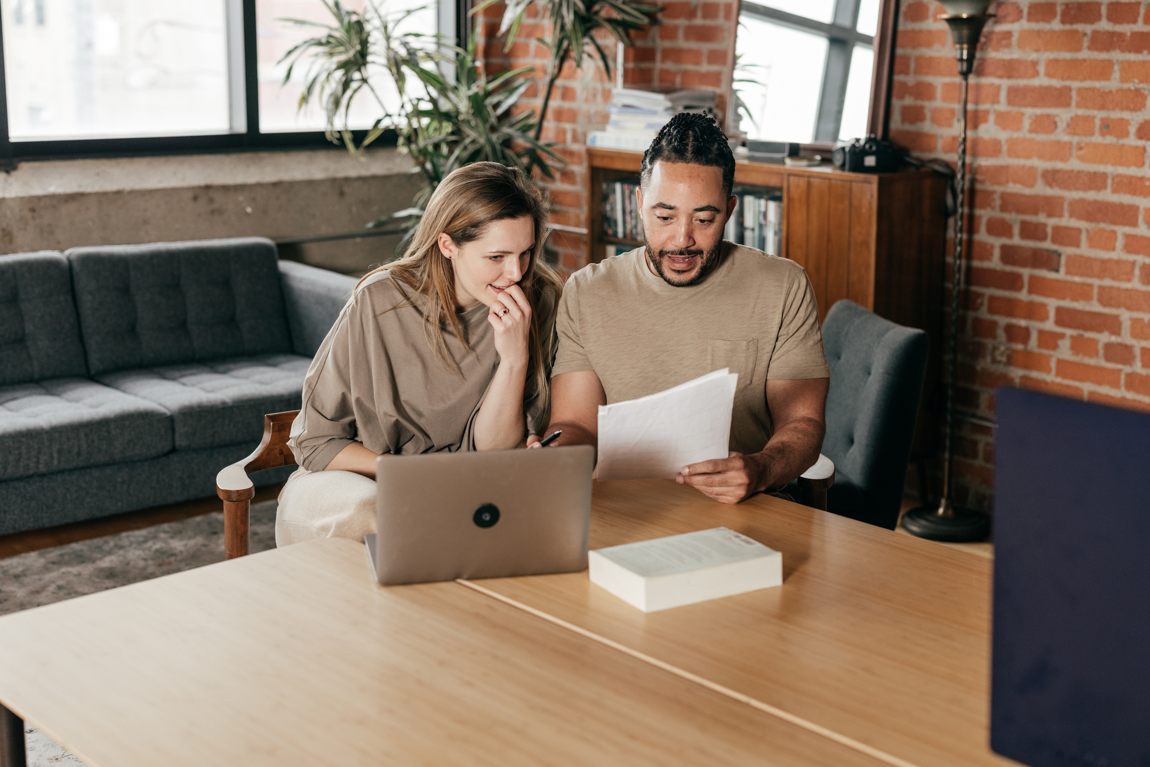 A man and woman looking at papers