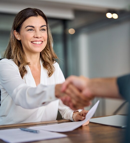 Young woman shaking hands with HR professional after an interview