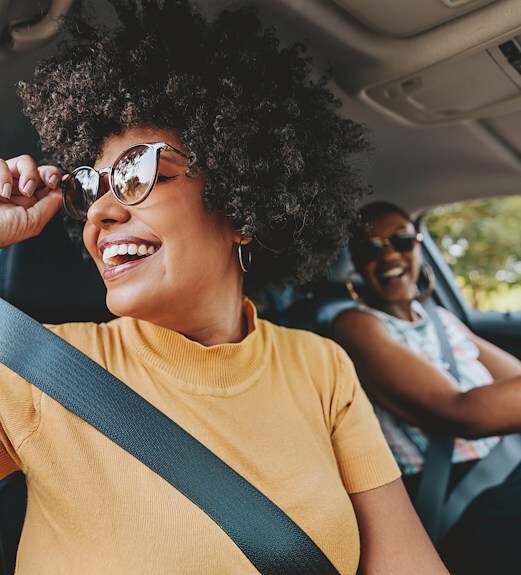 Two friends in a car having a fun drive together