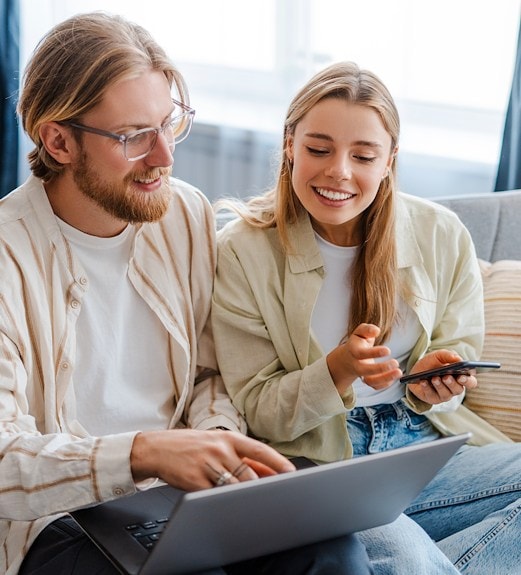 Young couple checking out their monthly eStatement on their UCU digital banking account