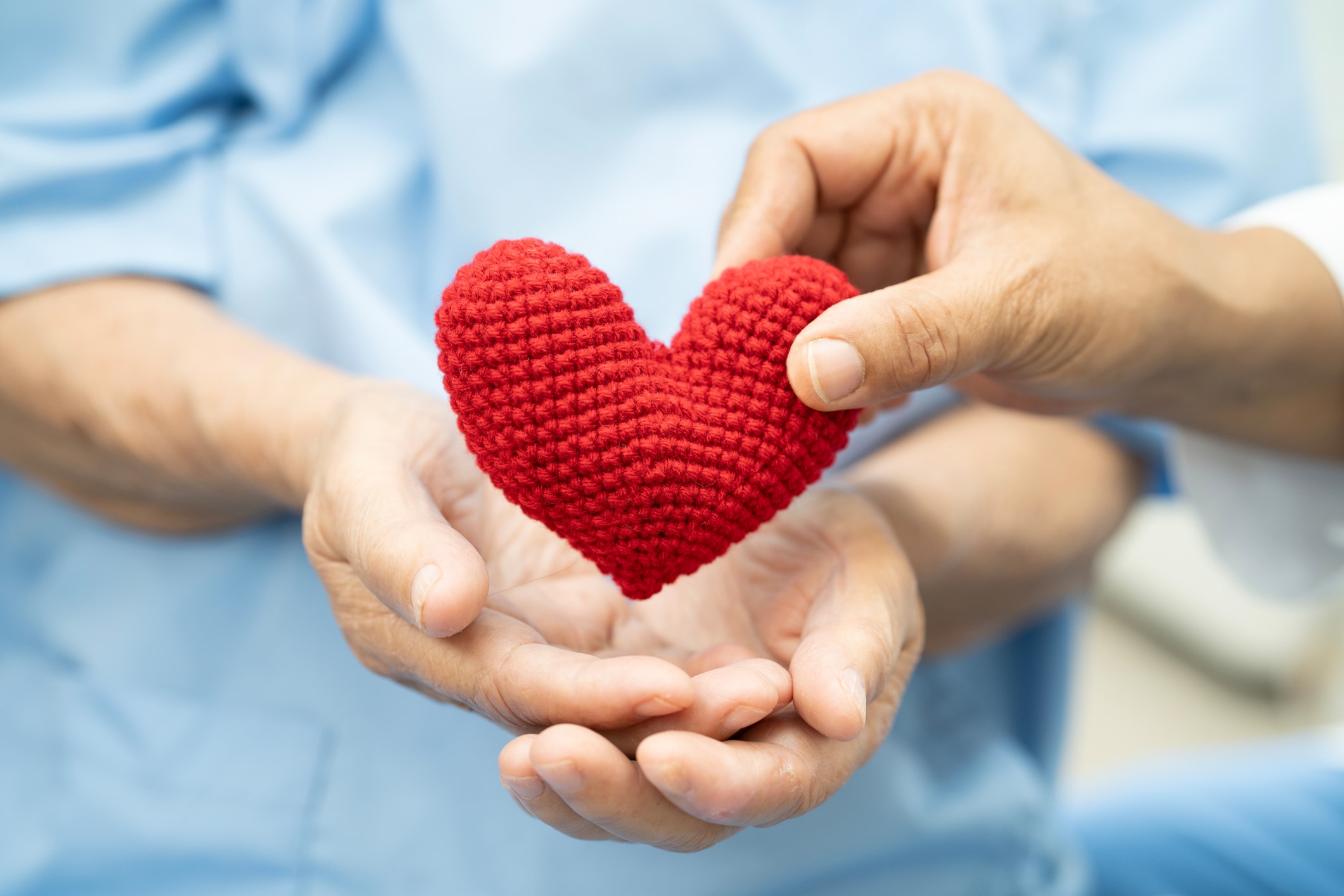 A person holding a red heart