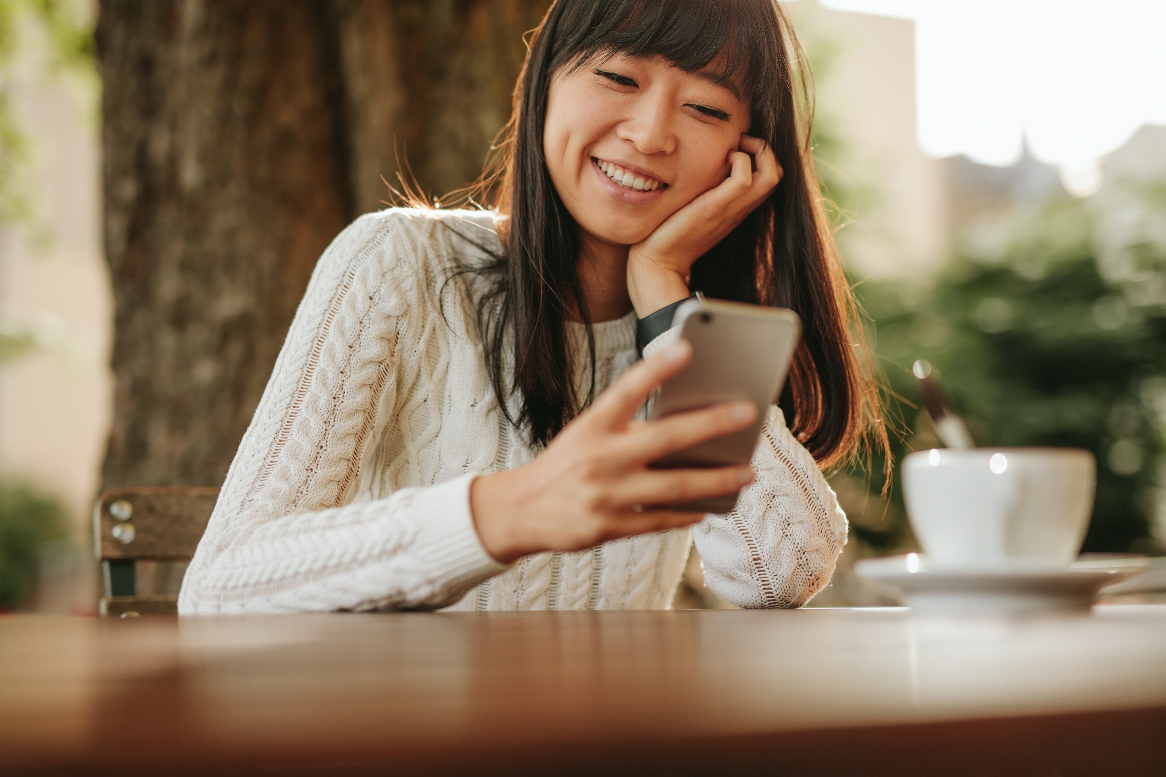 A woman smiling at a phone