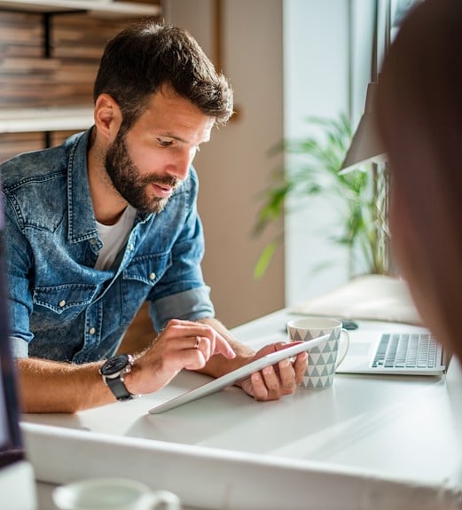 Business owner checking a stop payment alert on his tablet
