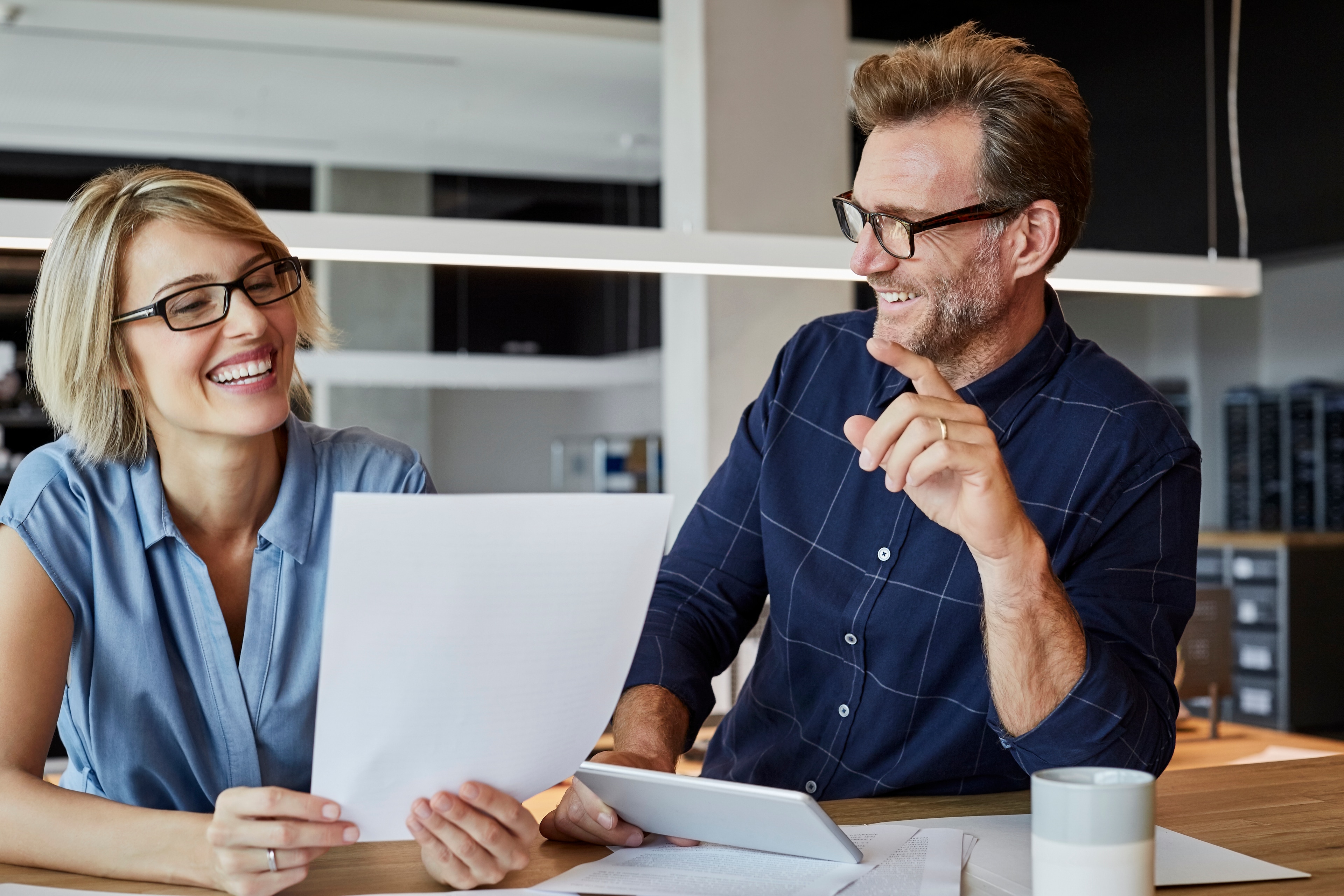 A man and woman looking at papers