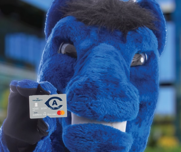 UC Davis mascot holding up the official Aggie debit card