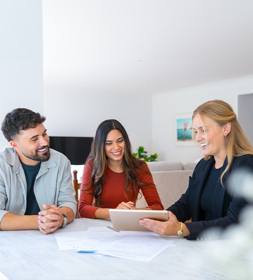 Close up view of two women holding out their house keys