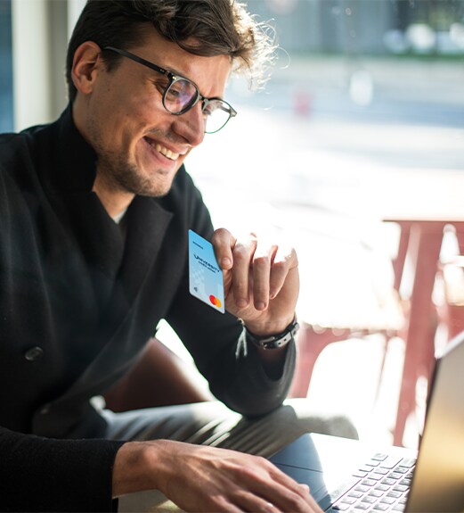 Man in a shop making a tap to pay purchase with his credit card