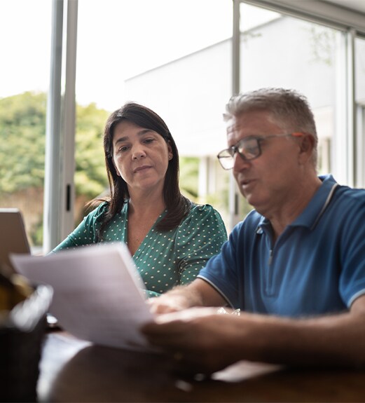 Man and woman checking fees on a sheet of paper