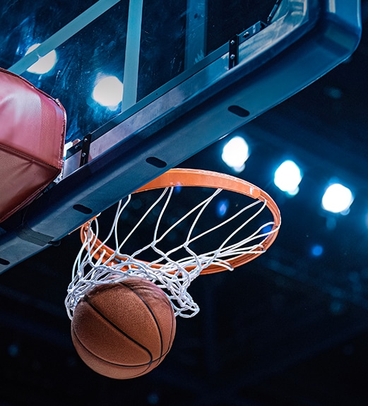 Close up view of basketball swishing through the net in the goal