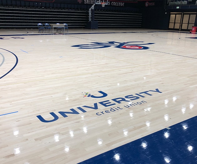 SMC basketball court showing UCU logo on it