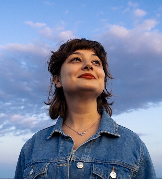 Woman looking up confidently at the sky