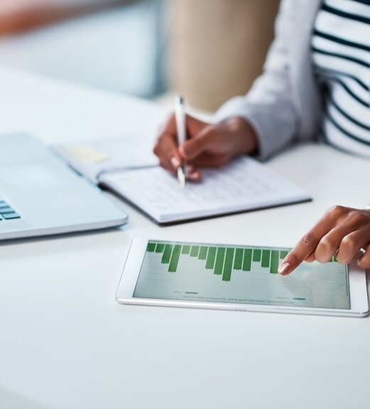 Close up view of a person reviewing charts on their tablet