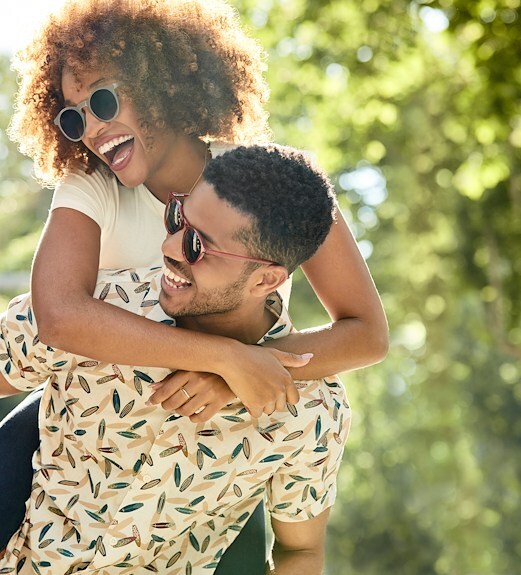 Happy young couple walking around outside