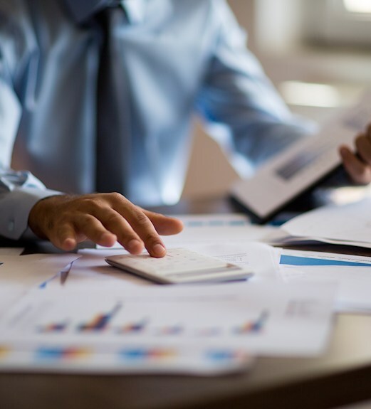 Close up view of a person reviewing charts and data