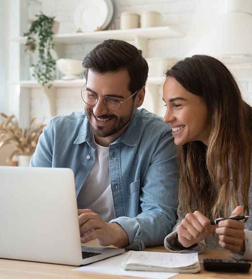 A couple browing the internet on their laptop