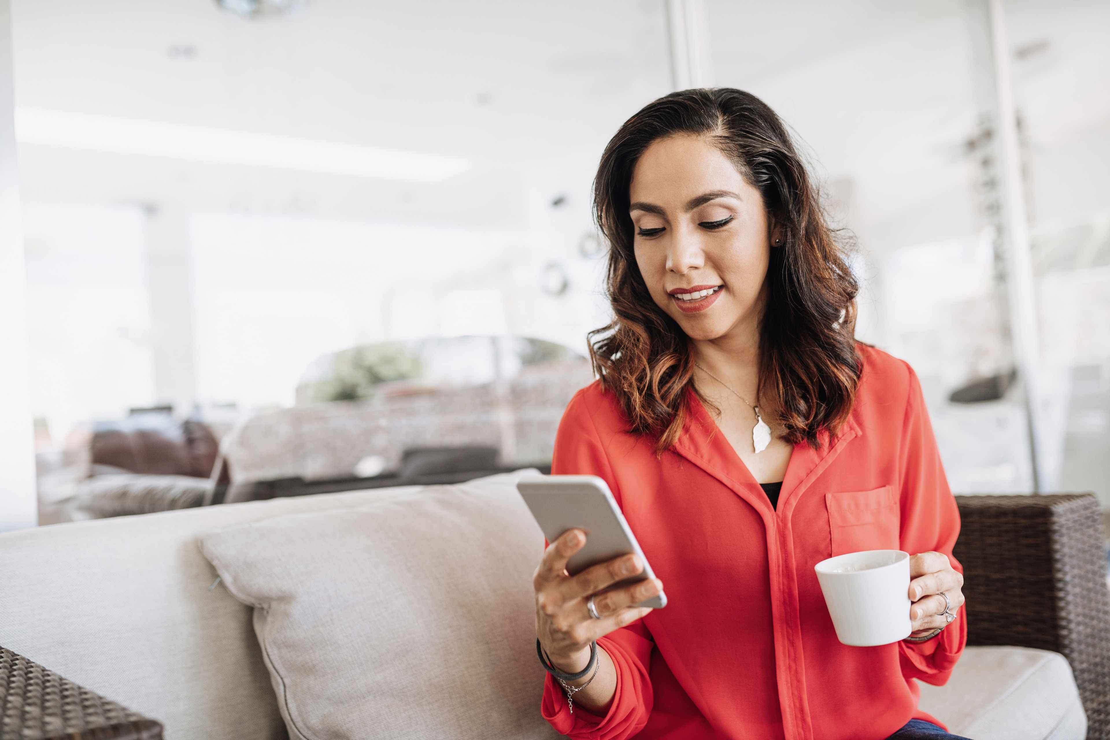 Woman checking her credit score on her phone at home