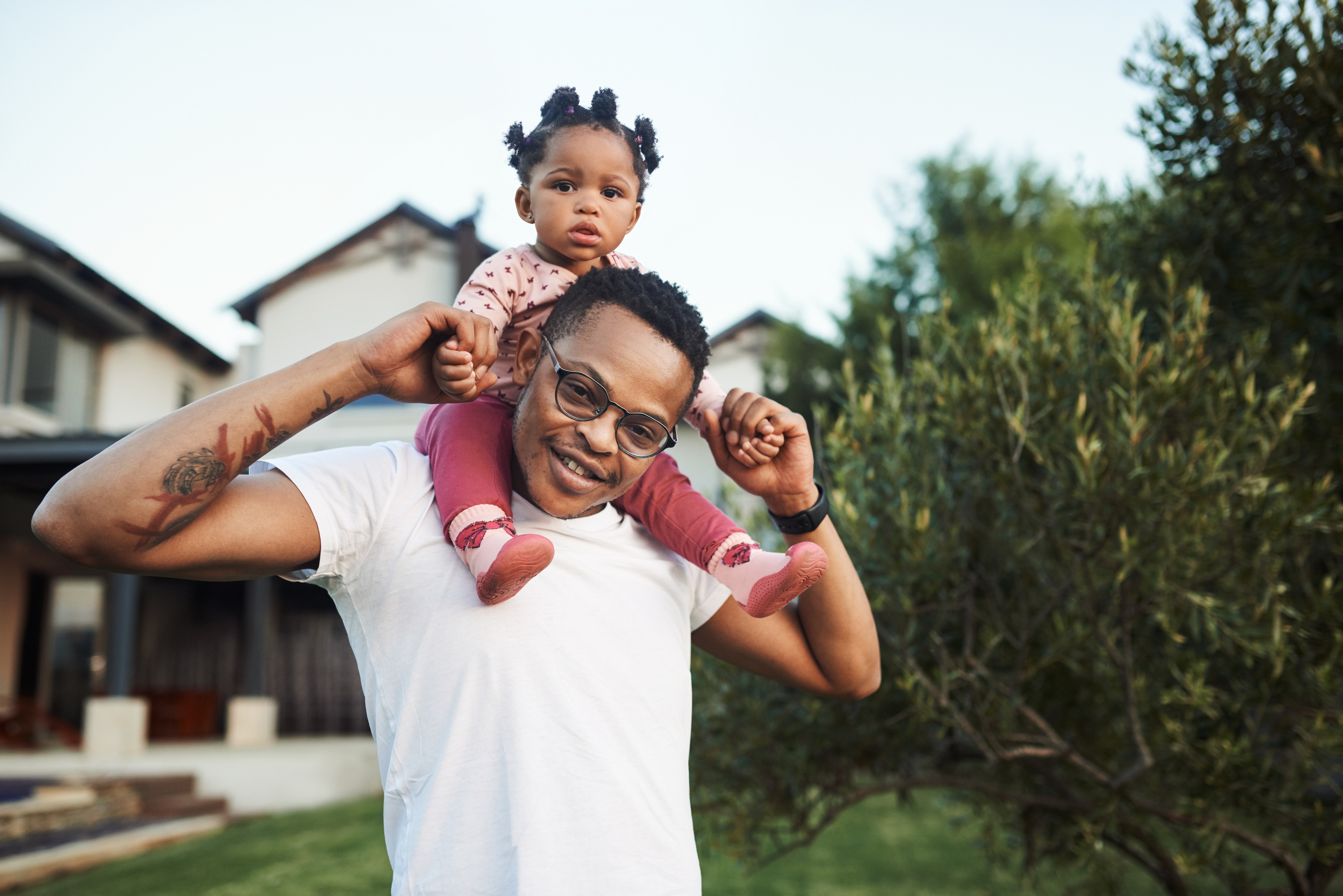 A man carrying a baby on his shoulders