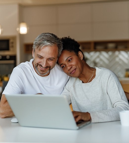 Couple looking at retirement account options on their computer together