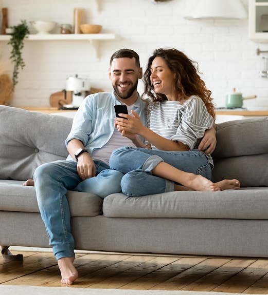 Young couple checking a financial account on their phone