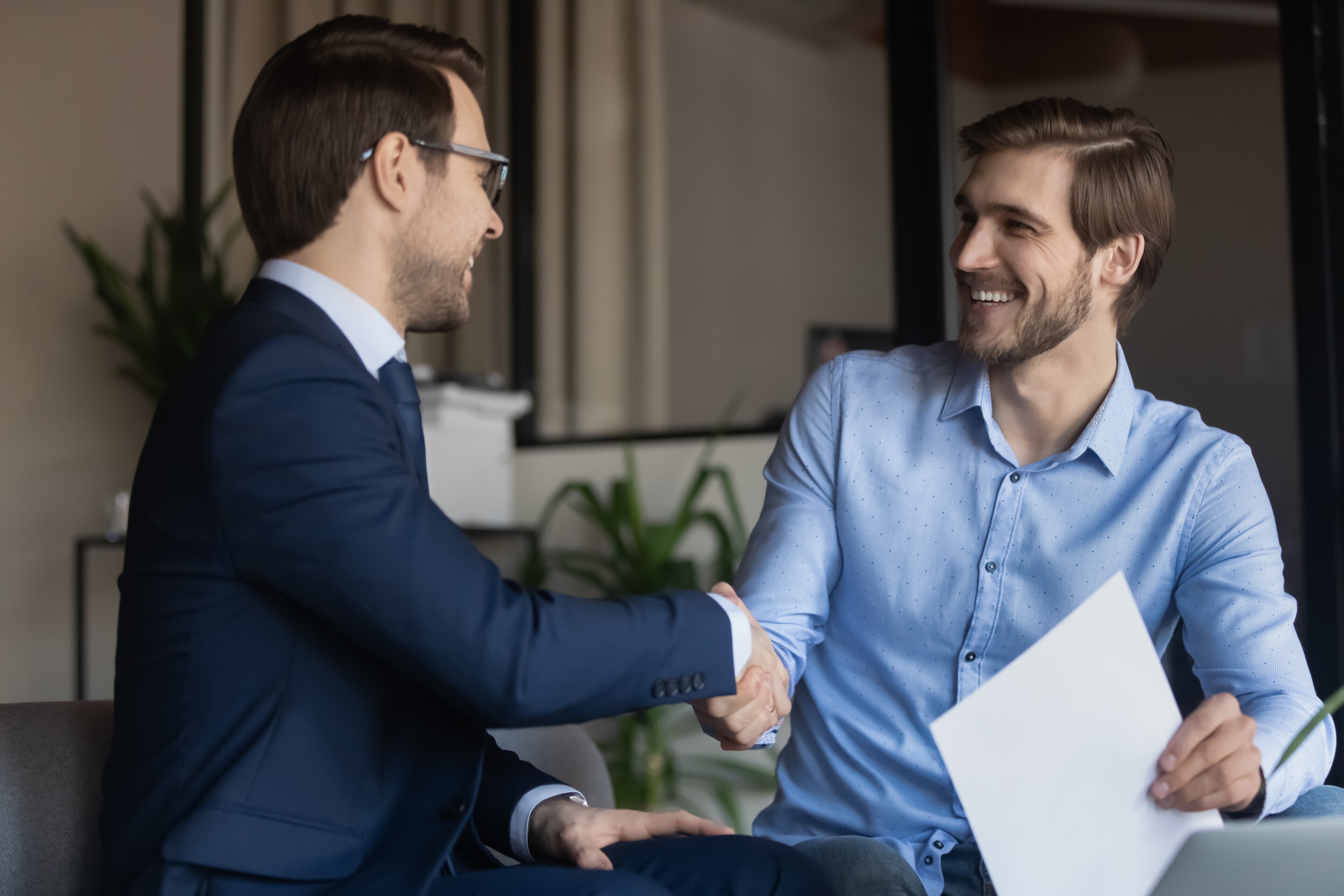Two people sharing a reassuring handshake
