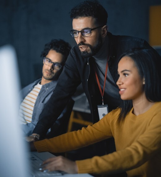 Security team of people viewing details on a computer screen
